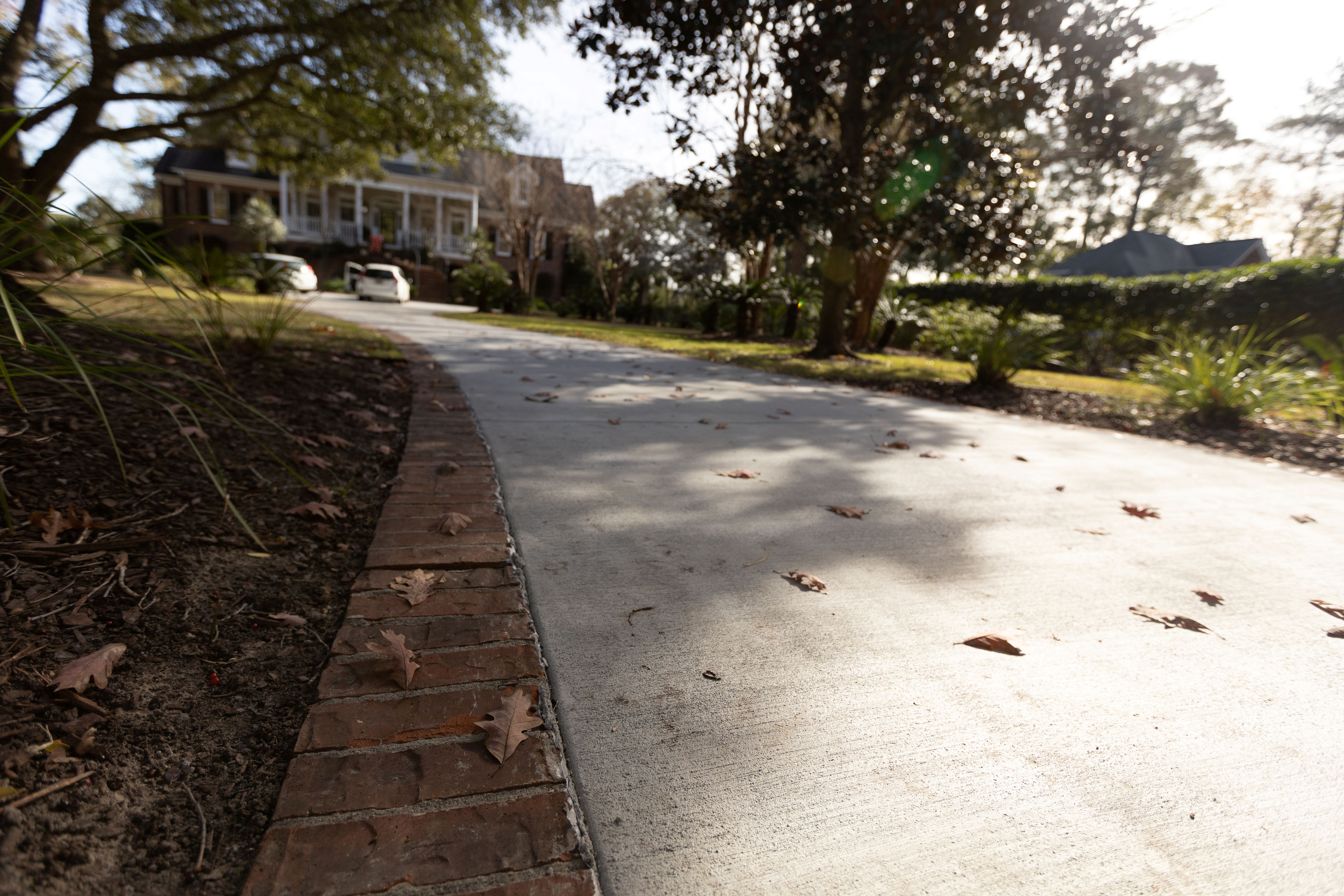 Colored Concrete Driveway - Isle of Palms SC Colored concrete driveway in Isle of Palms SC featuring custom integral color pigment, smooth trowel finish, decorative saw-cut control joints, weather-resistant sealer, and proper base preparation for coastal South Carolina salt air and humidity conditions