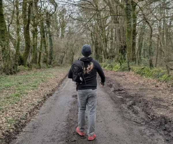 Dean Cooper walking through woodland path — Street Therapy journey
