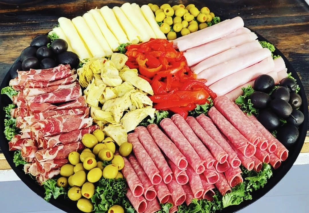 Italian charcuterie board with salami, prosciutto, olives, artichokes and fresh mozzarella from Palleschi Pizza catering