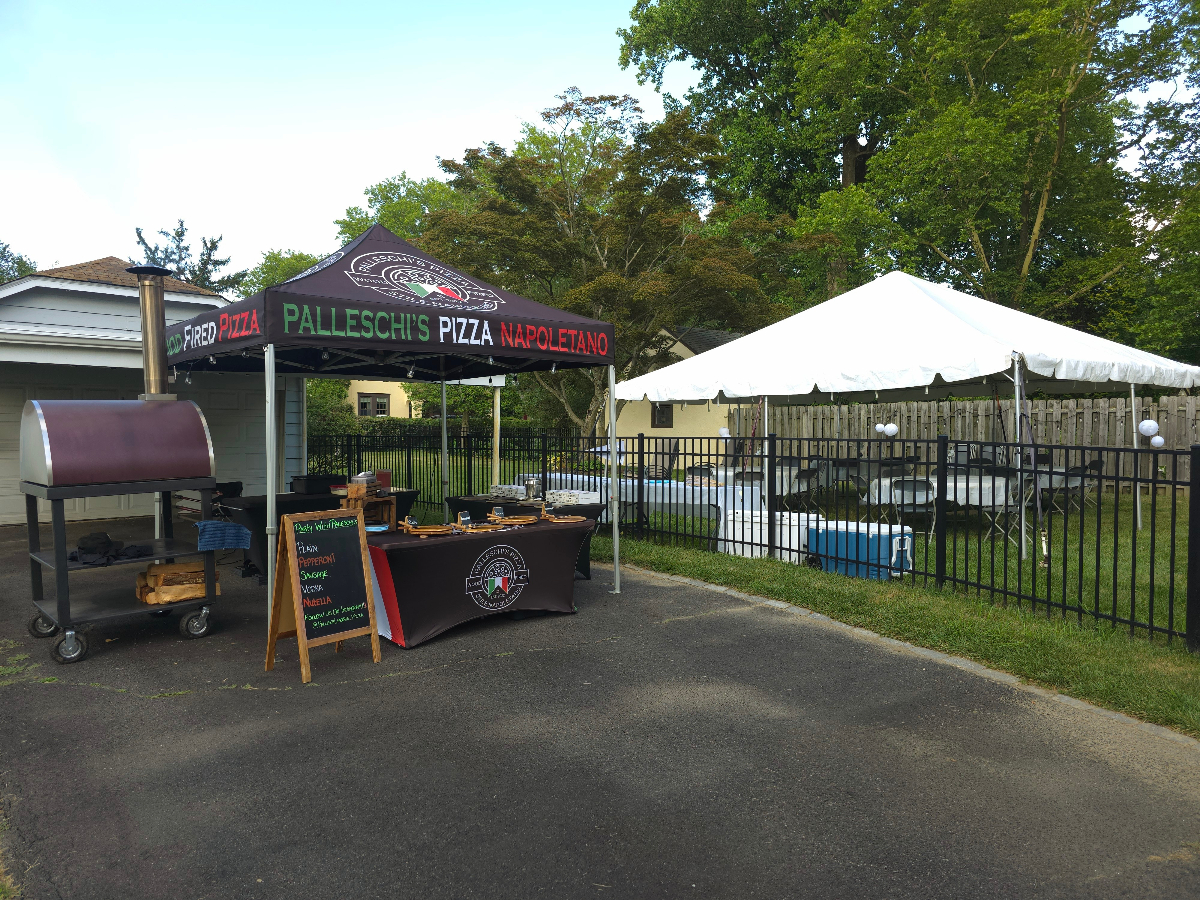 Palleschi's Pizza Napoletano setup at outdoor backyard event with wood-fired oven
