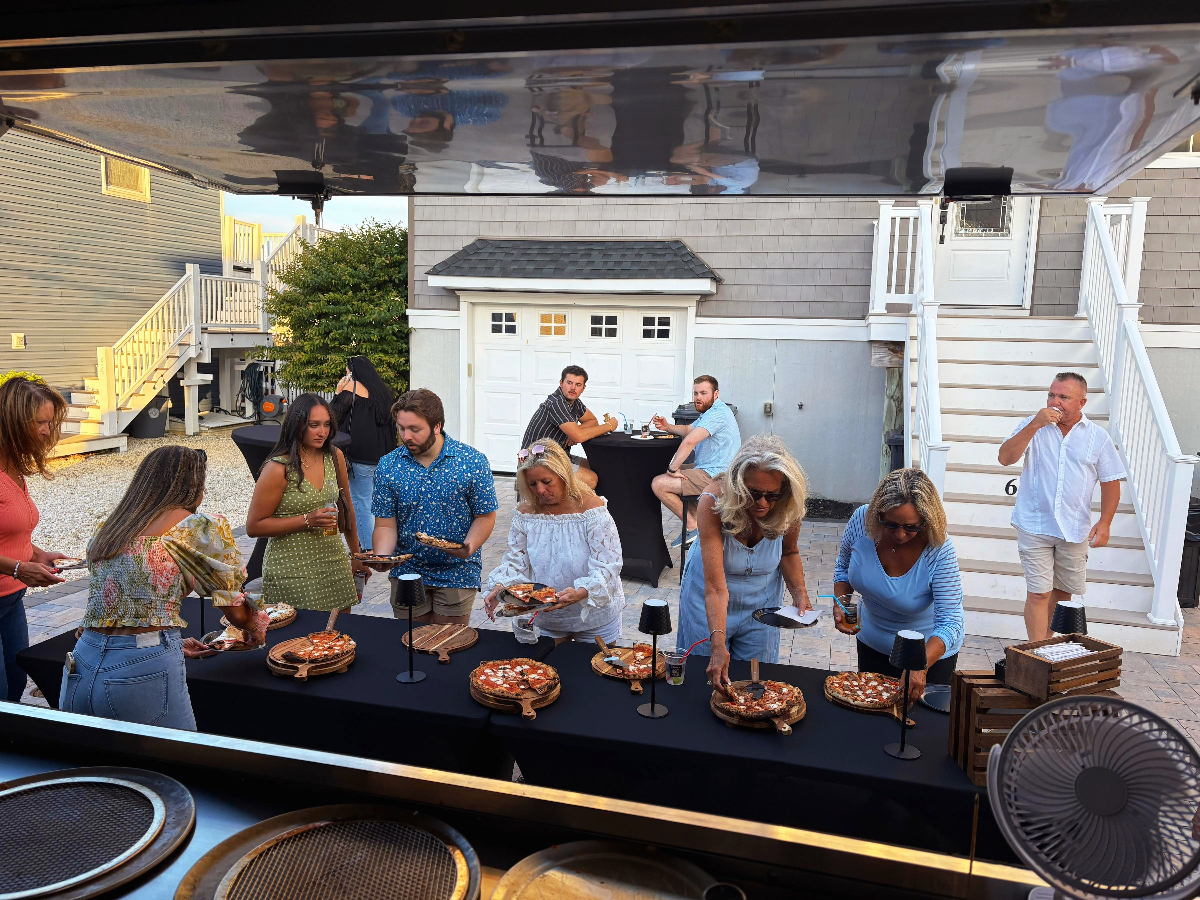 Guests enjoying Palleschi Pizza catering at outdoor backyard event