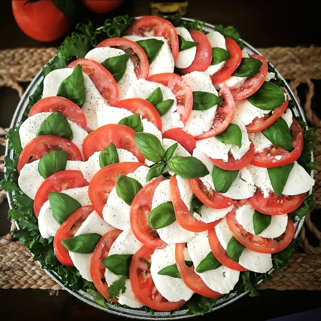 Fresh caprese salad with mozzarella, tomatoes and basil from Palleschi Pizza catering