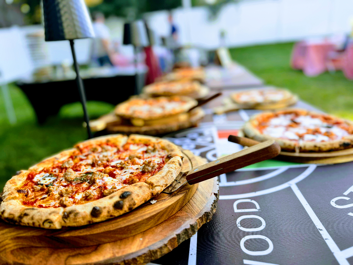 Palleschi Pizza wood-fired pizzas on boards at outdoor event