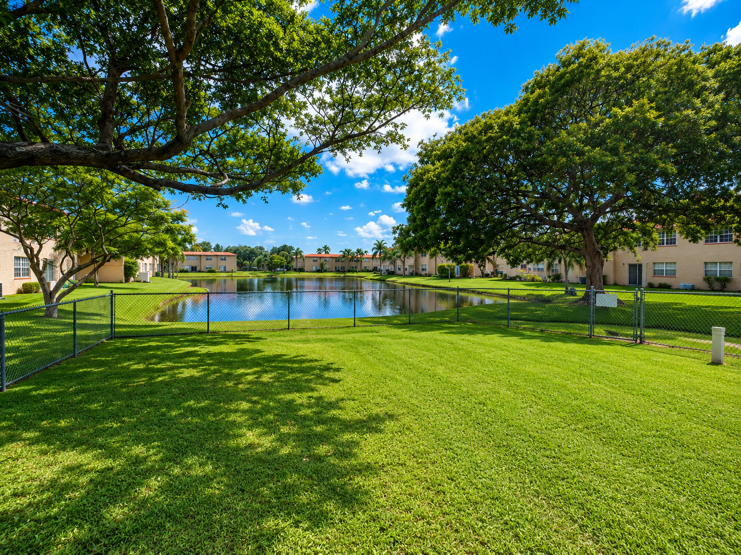 Windmill Lakes fenced dog park with open turf and benches